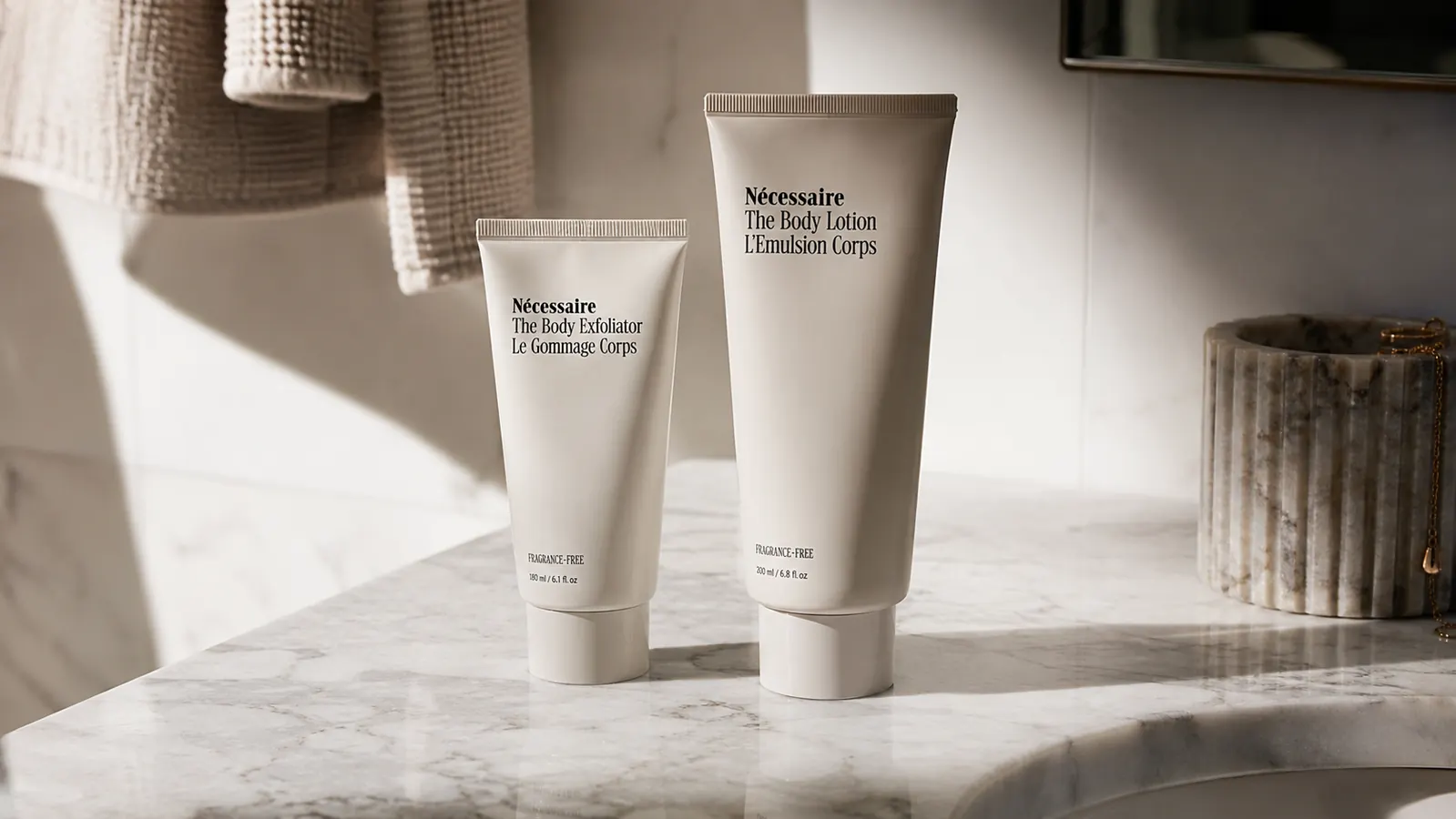 Two tinted mineral sunscreen tubes side by side on a bathroom counter in morning light
